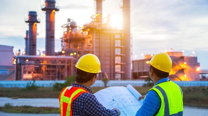 Industrial engineering working in a power plant, teamwork twilig